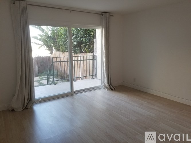 A room with a sliding glass door leading to a backyard.