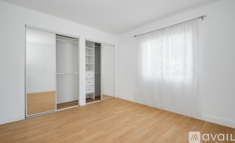 A room with a sliding door and a wardrobe.