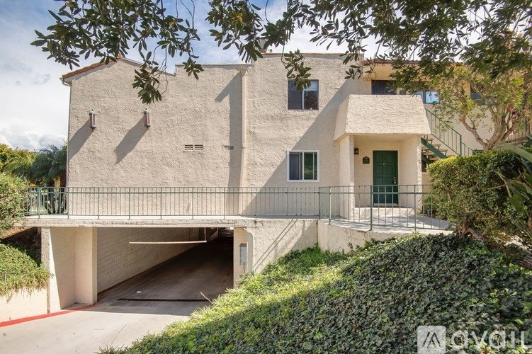 A modern house with a garage and a balcony.