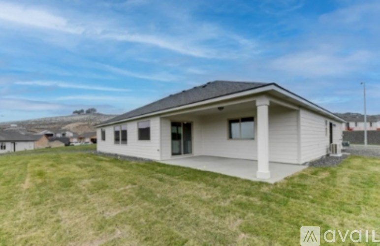 A house with a white exterior and a grey roof is for sale.