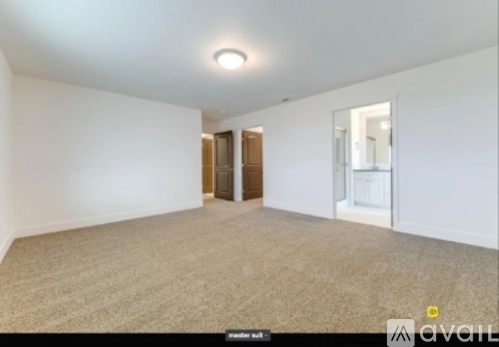 A room with beige carpet and white walls.