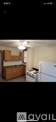 A kitchen with wooden cabinets and a white refrigerator.