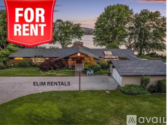 A house is for rent, as indicated by the sign in the front yard.