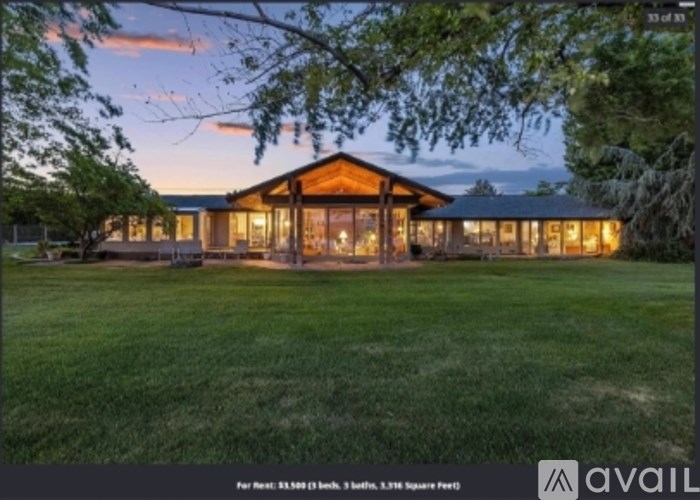 A house with a large front yard is for sale.