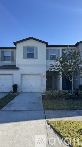 A two-story house with a garage is shown in the image.