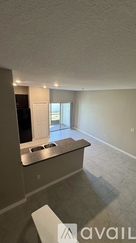 A kitchen area with a sink and a window.