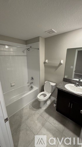 A bathroom with a toilet, sink, and bathtub.