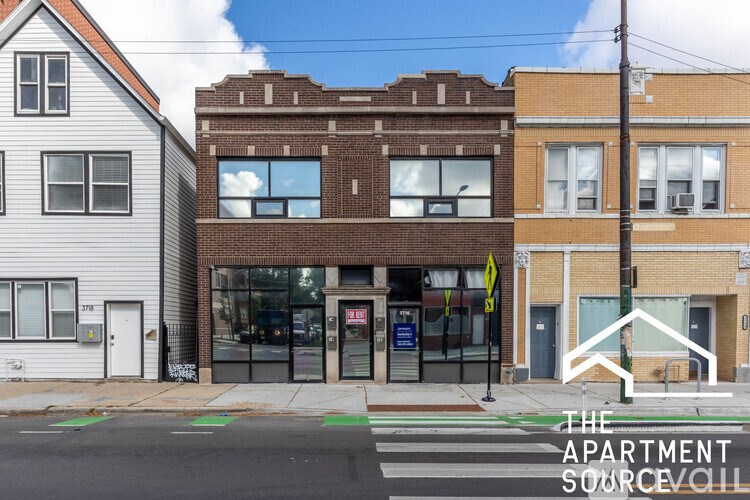 A street view of a building with the text "The Apartment Source" on the bottom right.