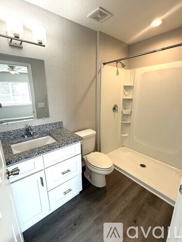 A bathroom with a sink, toilet, and bathtub.