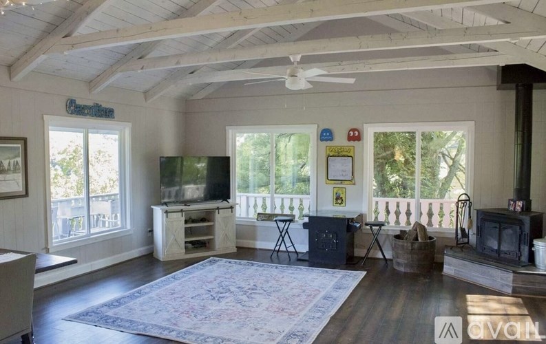 A living room with a fireplace and a television.