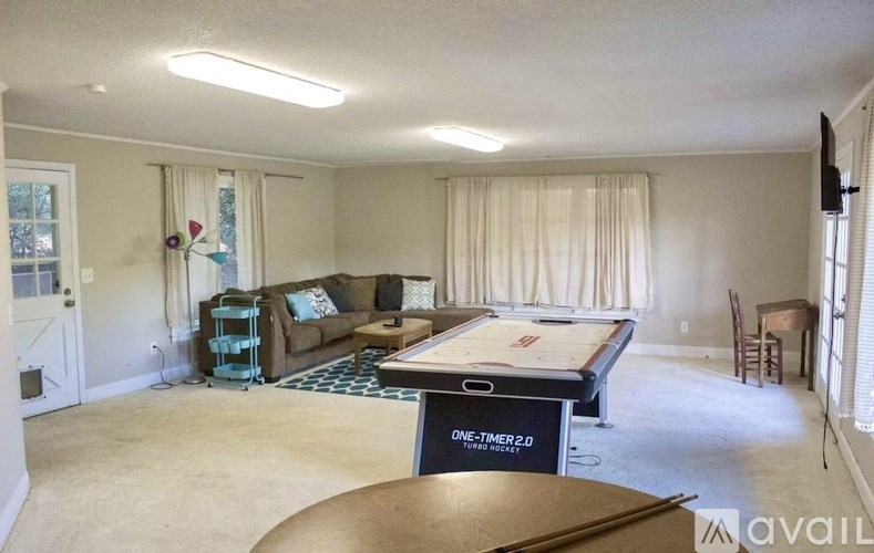 A room with a pool table and a couch.