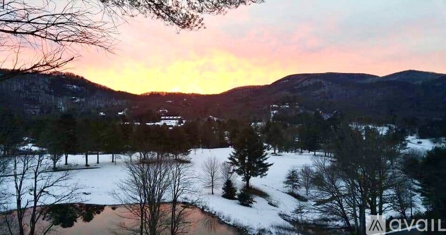 A beautiful landscape with a sunset and snow-covered ground.
