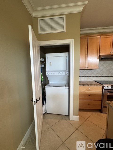 A kitchen with a white refrigerator and a stove top oven.