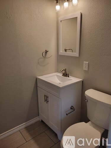 A white sink and toilet in a bathroom.