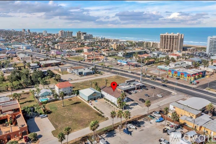 A red marker is placed on a building in a parking lot.