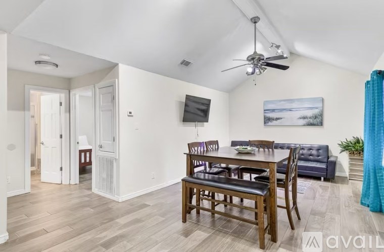 A living room with a dining table and chairs.