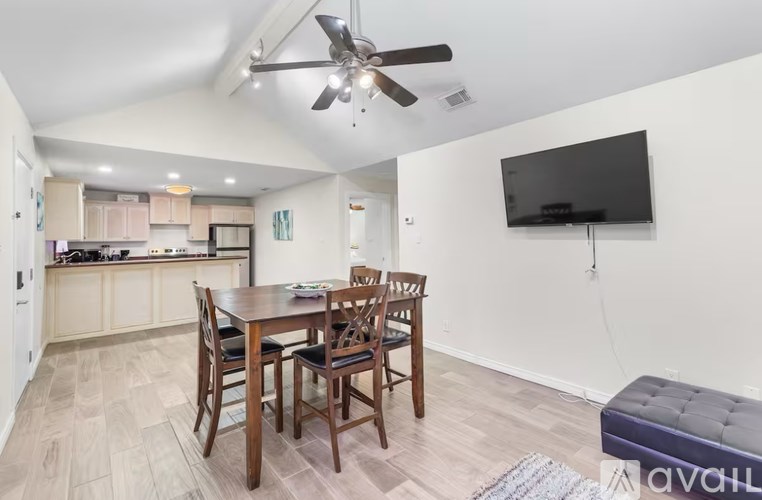 A modern kitchen with a dining table and chairs.