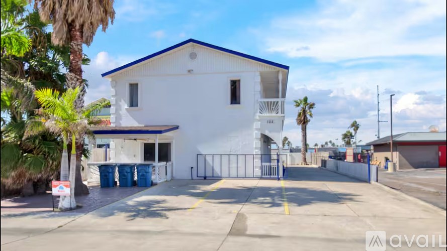 A white building with a blue roof and a sign that says "available" in front of it.