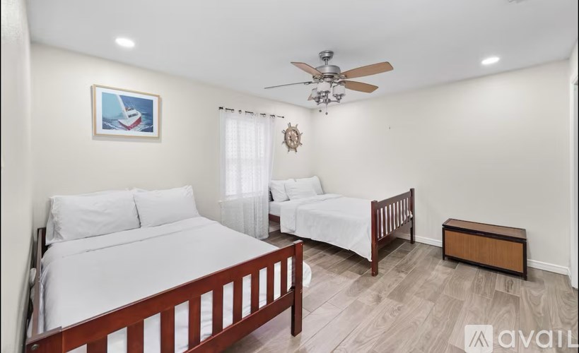 A bedroom with a large bed and a smaller bed in the corner.