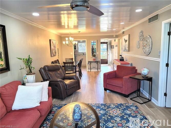 A living room with a red couch and a brown leather chair.