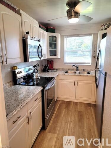 A kitchen with wooden cabinets and a black stove top.