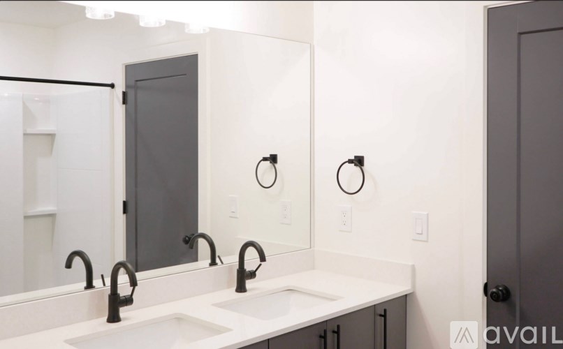 A bathroom with two sinks and a large mirror.