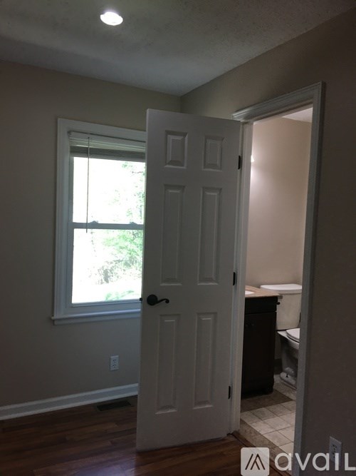 A white door is open to a bathroom.