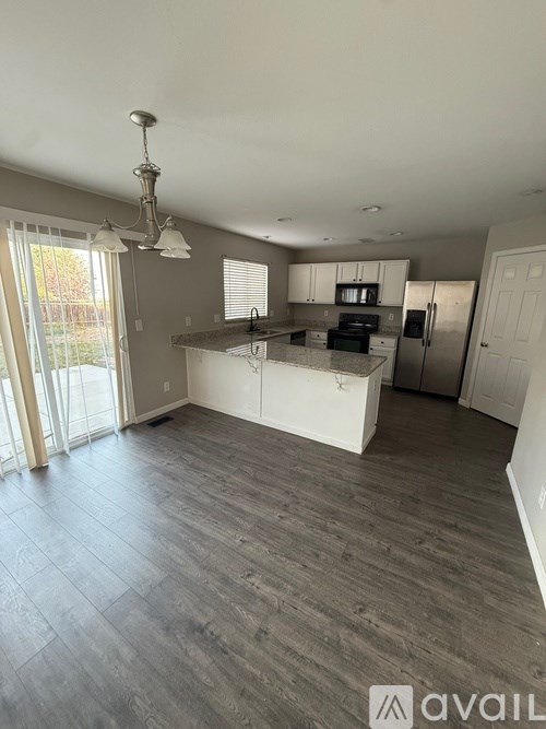 A spacious kitchen with a dining area and a large island.