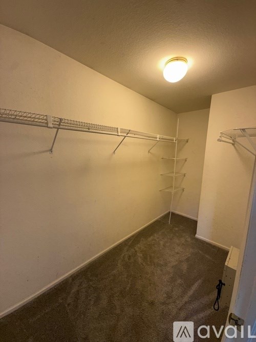 Empty room with a white wall and a shelf.