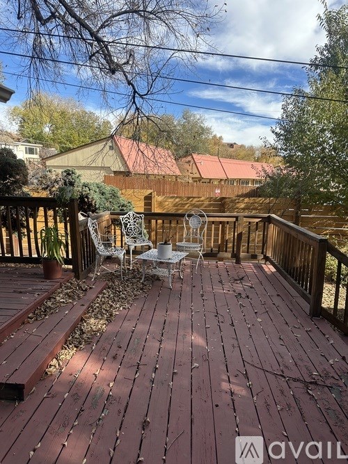 A wooden deck with a table and chairs.