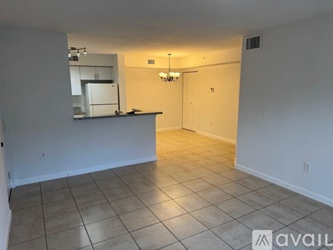 A kitchen area with a counter and a fridge.