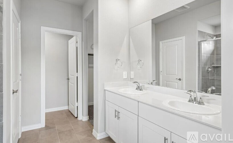 A bathroom with a white sink and a white door.