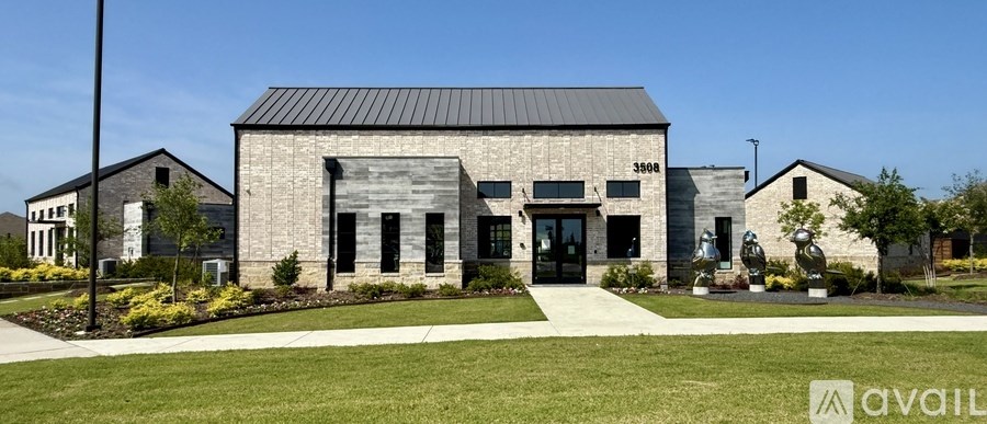 A modern building with a black roof and a sign that says "AVAIL" in front of it.