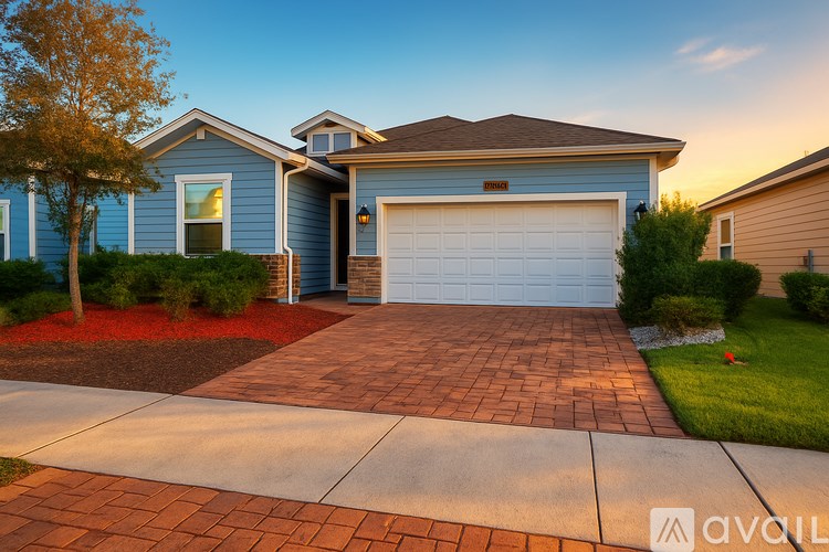 A house with a blue exterior and a white garage door.
