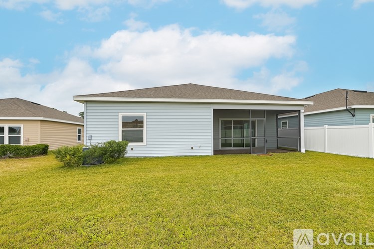 A house with a large lawn in front of it is for sale.