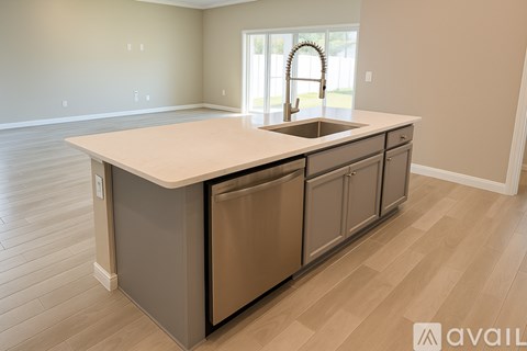 A kitchen with a sink and cabinets.