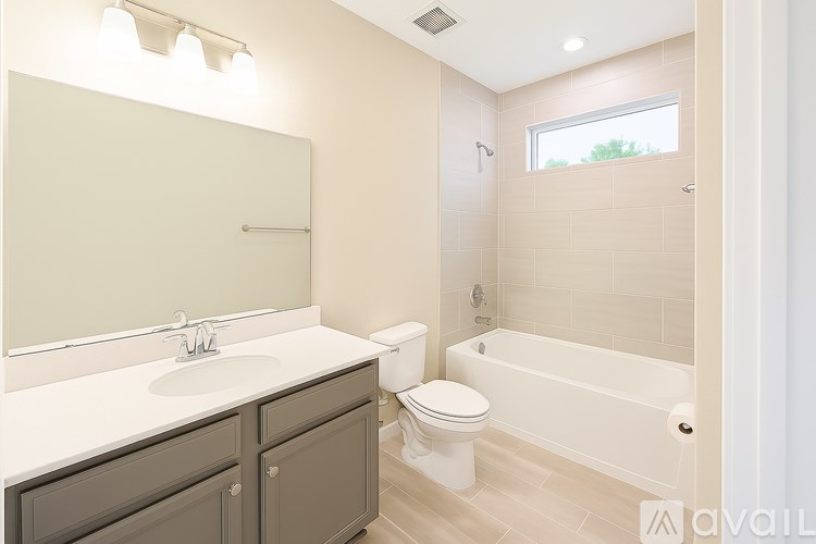 A bathroom with a white toilet, sink, and bathtub.