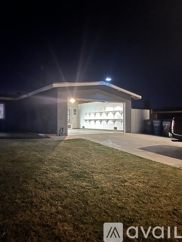 A building with a lit entrance at night.