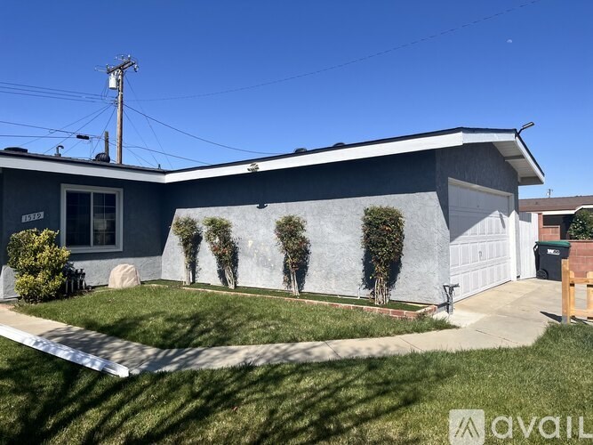 A house with a grey exterior and a white garage door.
