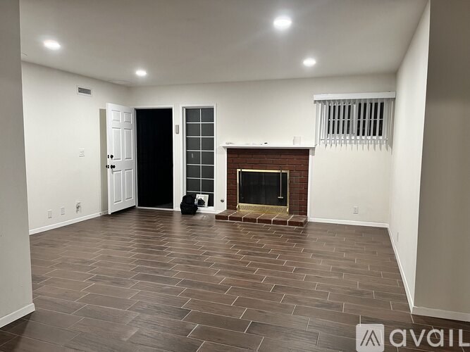 A room with a fireplace and a dog.