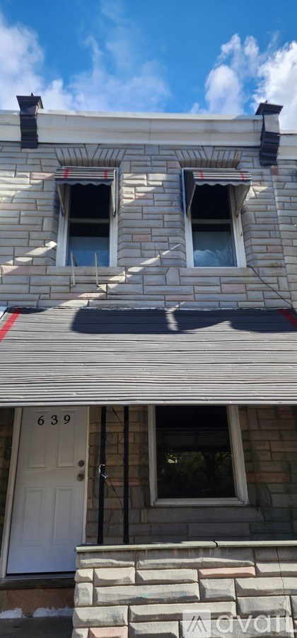 A house with a white door and two windows.
