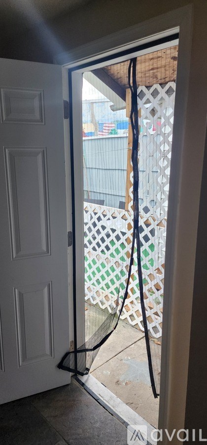 A white door with a black handle and a black frame.