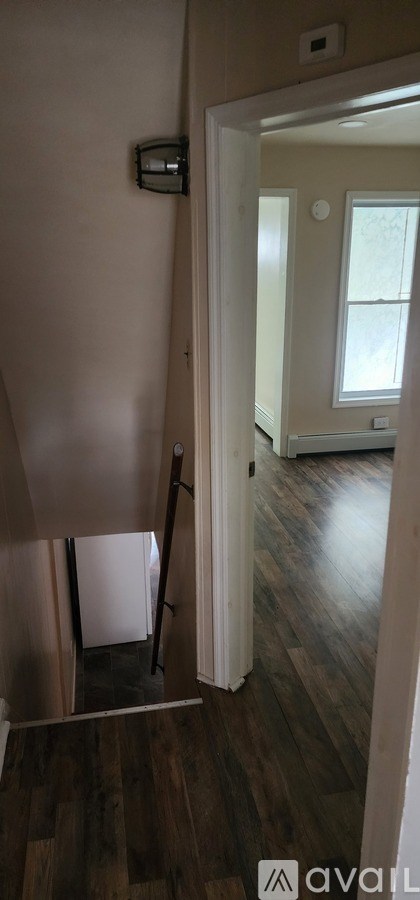 A room with a white door and a window.