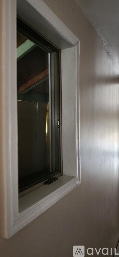 A white window frame with a glass pane in the middle.