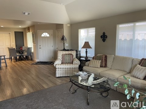 A living room with a couch, chair, and coffee table.