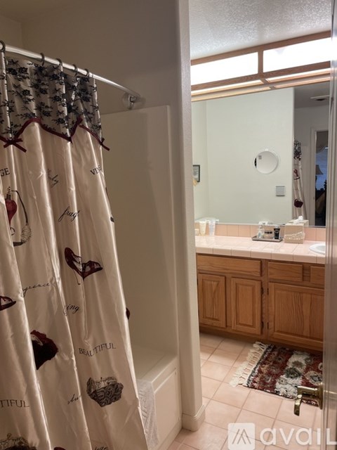 A bathroom with a shower curtain that has the word "beautiful" on it.