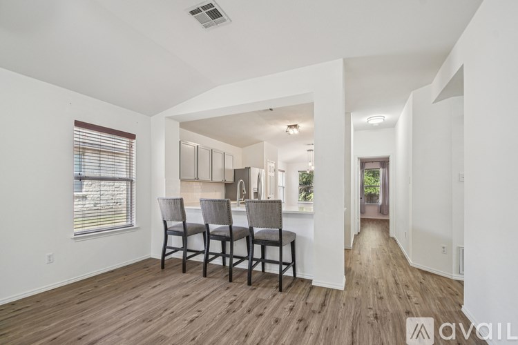 A room with a dining table and chairs is available for rent.