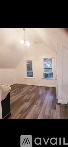 A room with wooden flooring and a window.