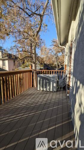 A wooden deck with a table and chairs on it.