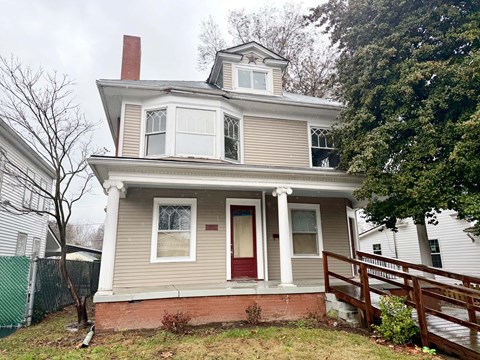 A house with a red door and a white porch.
